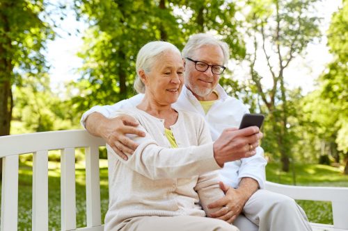 senior couple with smartphone taking selfie